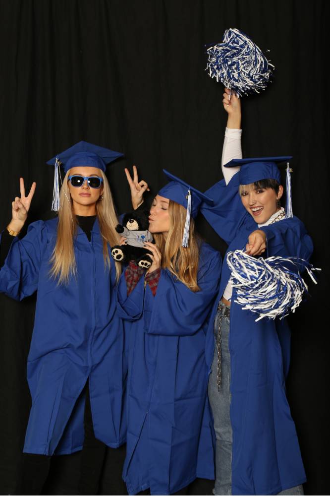 funny picture of three students with photobooth props